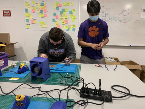 Gavin Frey 23 and Dylan Strauss 22 work on soldering for their upcoming drone build.