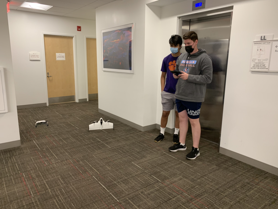 Gavin Frey 23 and Dylan Strauss 22, controlling the white drone, fly close to the winged drone.