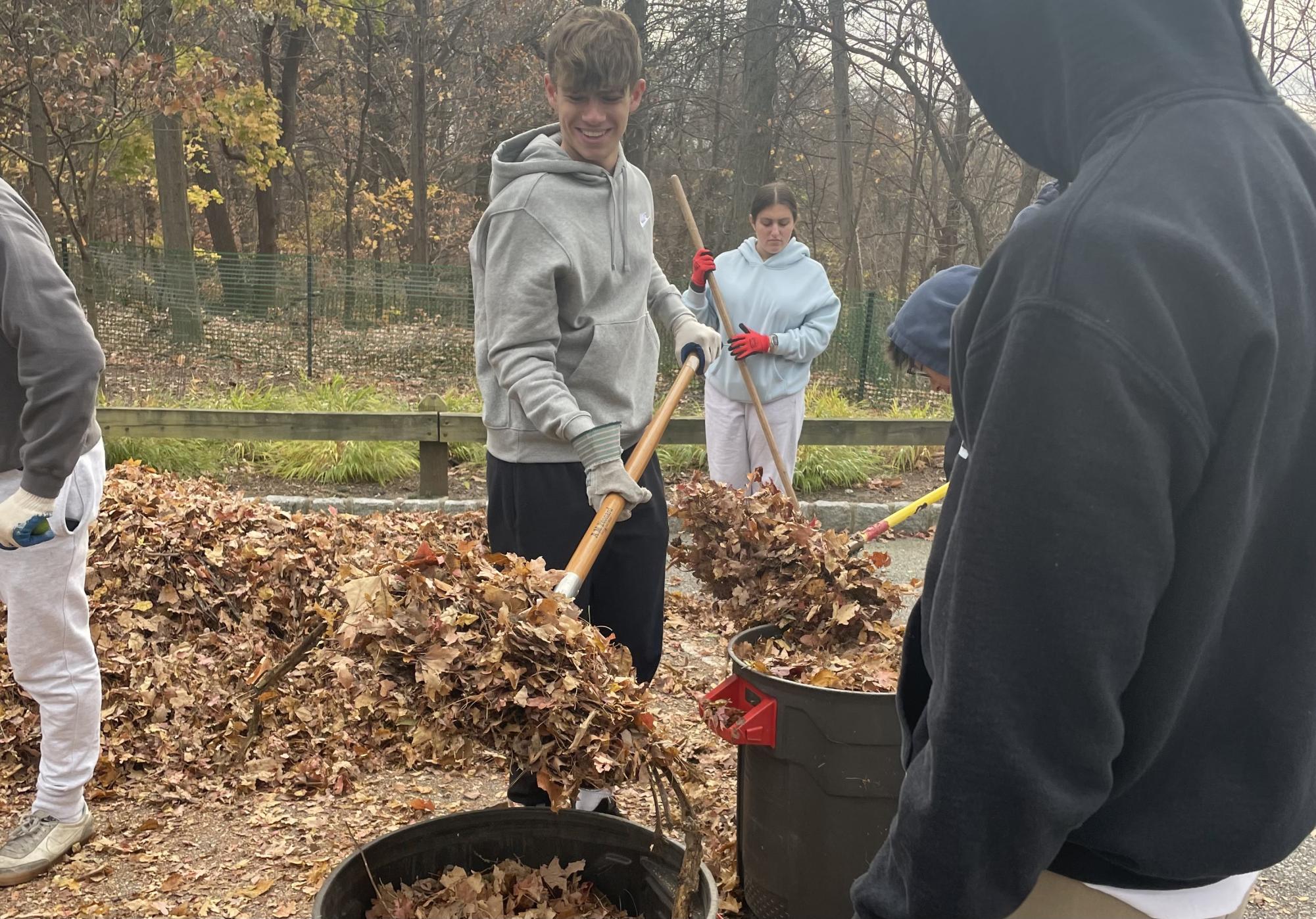 Cleaning up leaves as part of the service day.