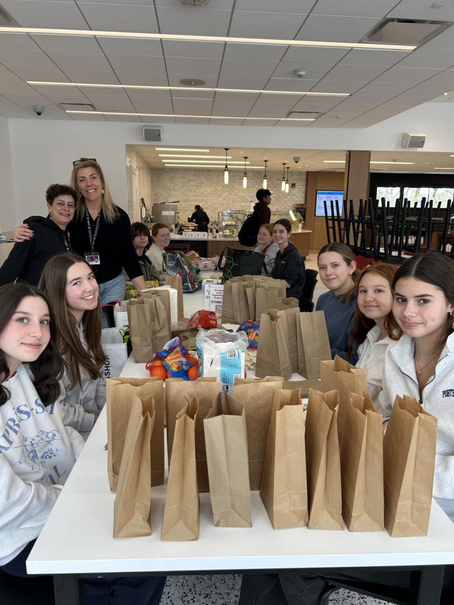 Students participating in the Day of Service by making sandwiches and snack bags for the Community Service Club. 